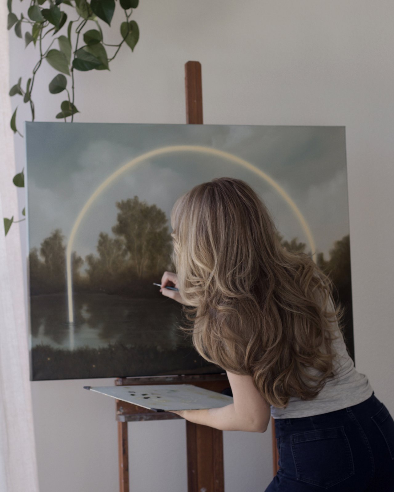 Savannah Morgan painting Firefly Lake at her easel